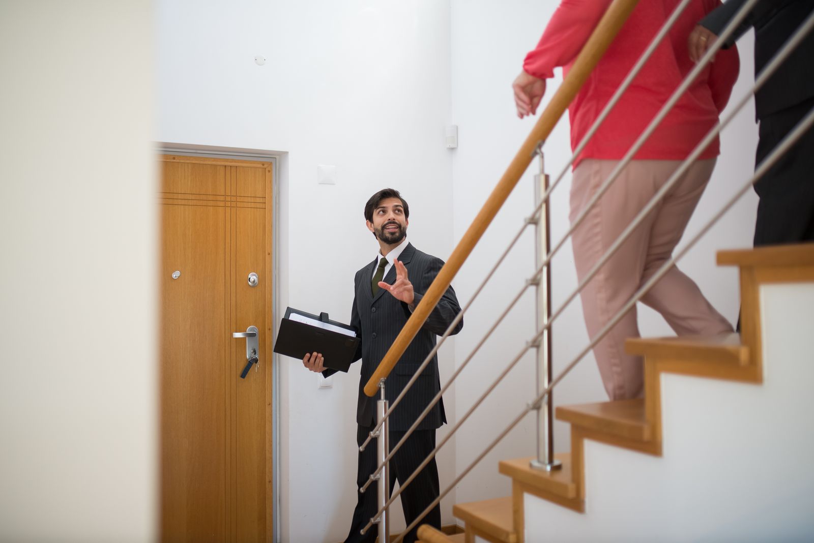 An agent walking buyers through a Charleston house